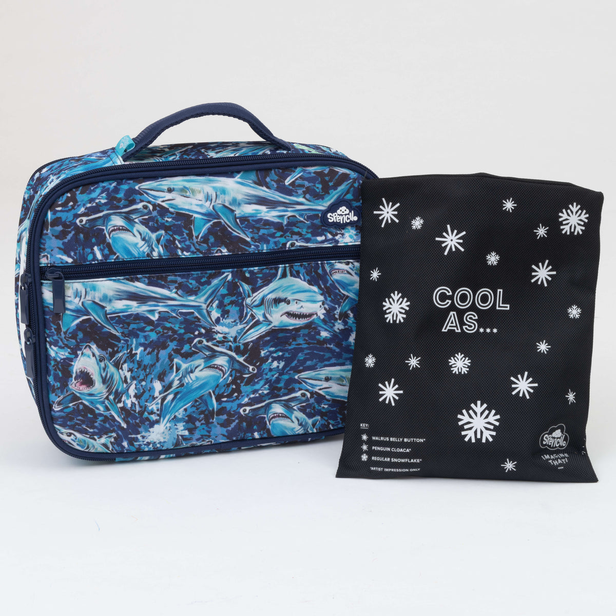 Spencil Fin Frenzy Big Cooler Lunch Bag photographed beside the Big Chill Pack in its black snowflake cover, showing the deep ocean blue print packed with swimming sharks, with a navy handle and zips