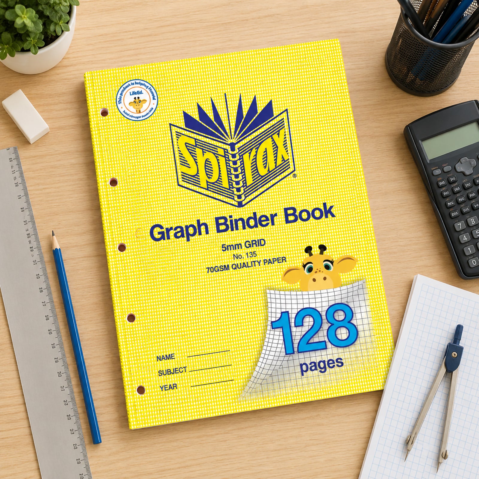 Top view of the Spirax 135 A4 Graph Binder Book on a wooden desk surrounded by a calculator, ruler, compass, pencils, graph paper and stationery, highlighting the binder format and 128 page capacity.