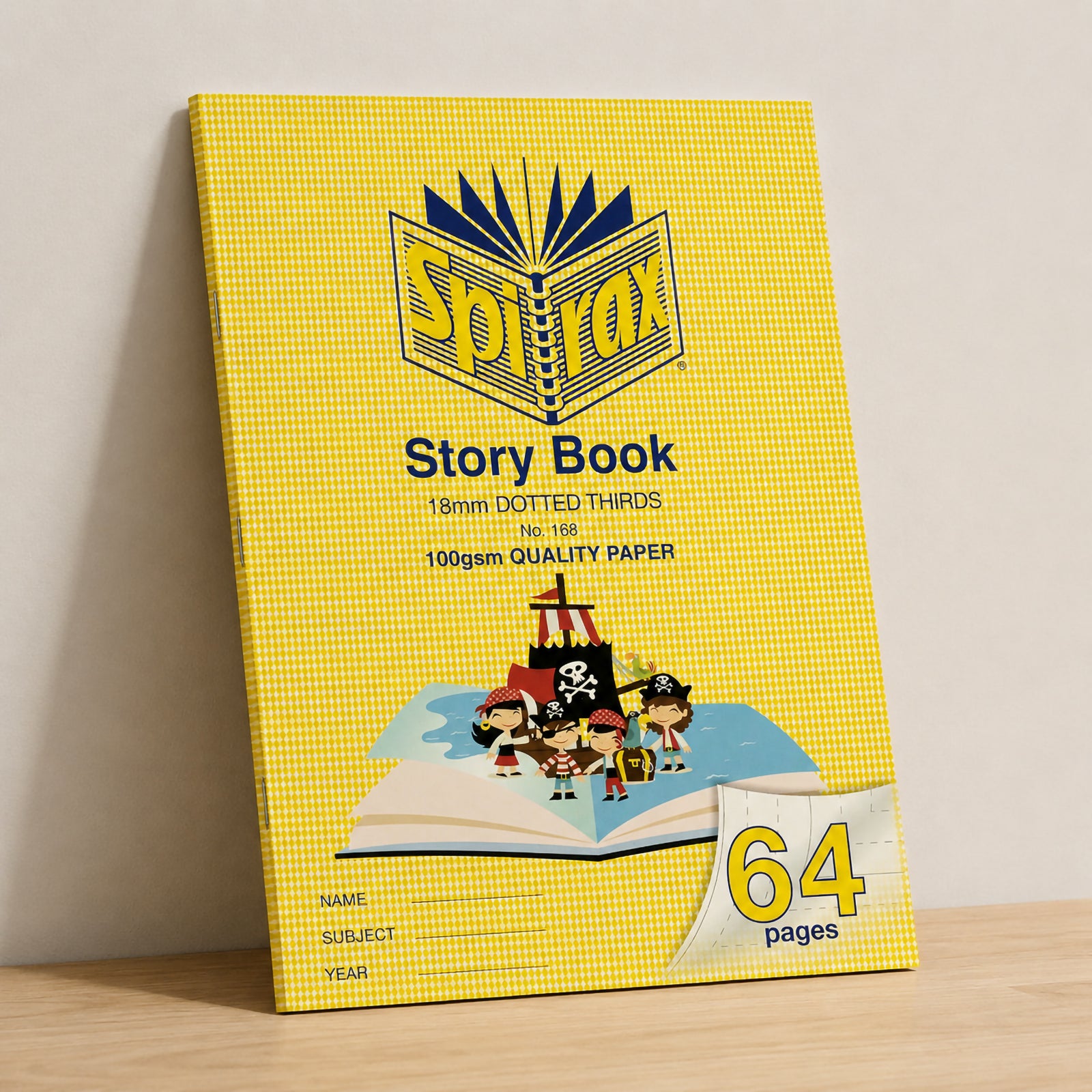 Spirax 168 Story Book standing upright against a neutral wall with soft natural lighting on a timber shelf, displaying the large 328 x 240mm format and durable yellow cover suitable for classroom use.