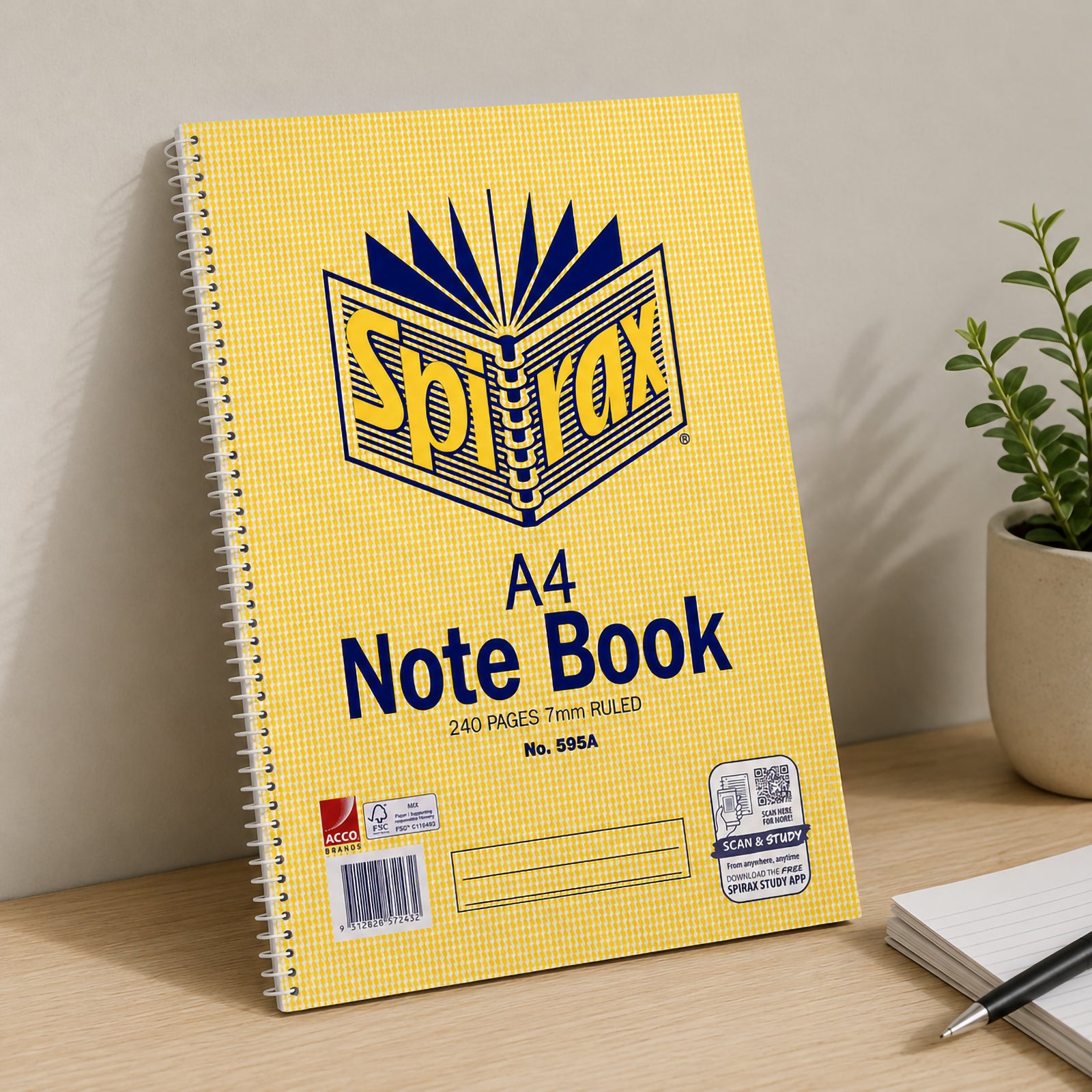 Spirax 595A A4 Note Book standing upright against a neutral wall with a plant and writing pad nearby, showing the yellow cover, side spiral binding and 240 page format.