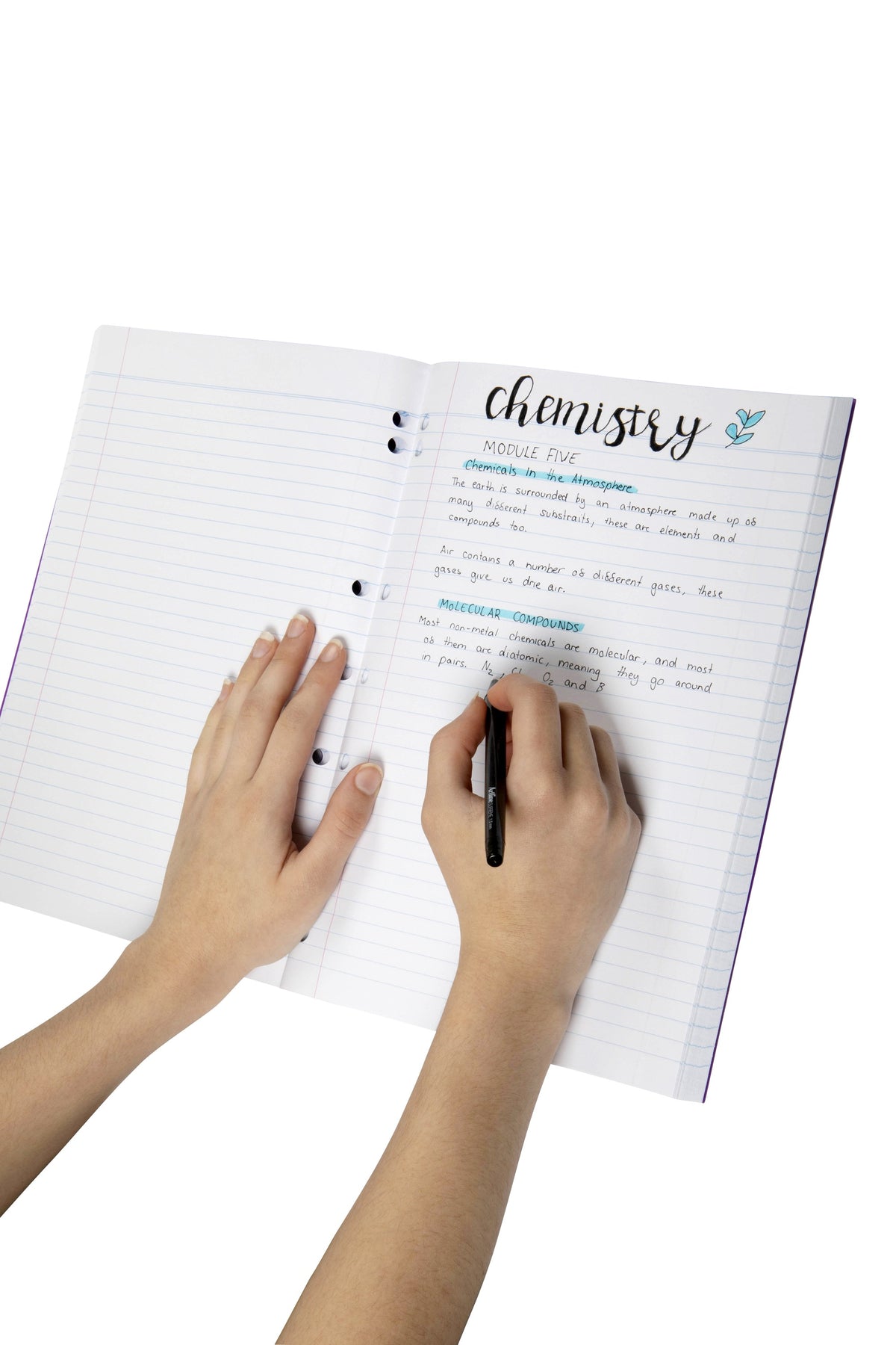 Student writing chemistry notes on the 8mm ruled pages of an open Spirax P128 A4 binder book, punched holes visible along the inner edge