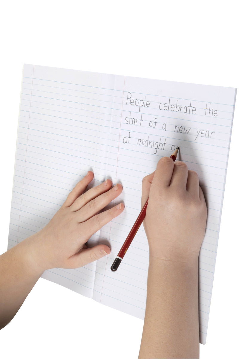 A young writer printing a sentence in pencil on the wide 24mm dotted thirds lines of an open Spirax 105 exercise book