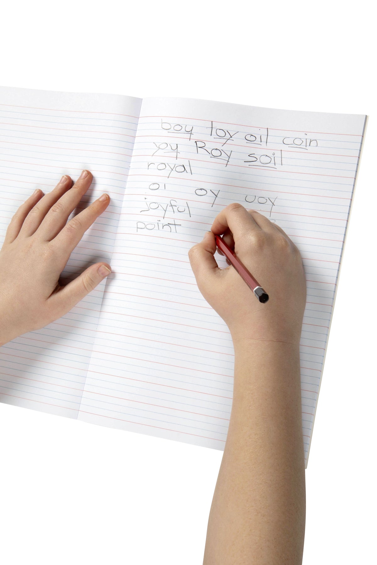 Child writing word lists in pencil on the red and blue Year 2 QLD ruling of an open Spirax 204 A4 exercise book