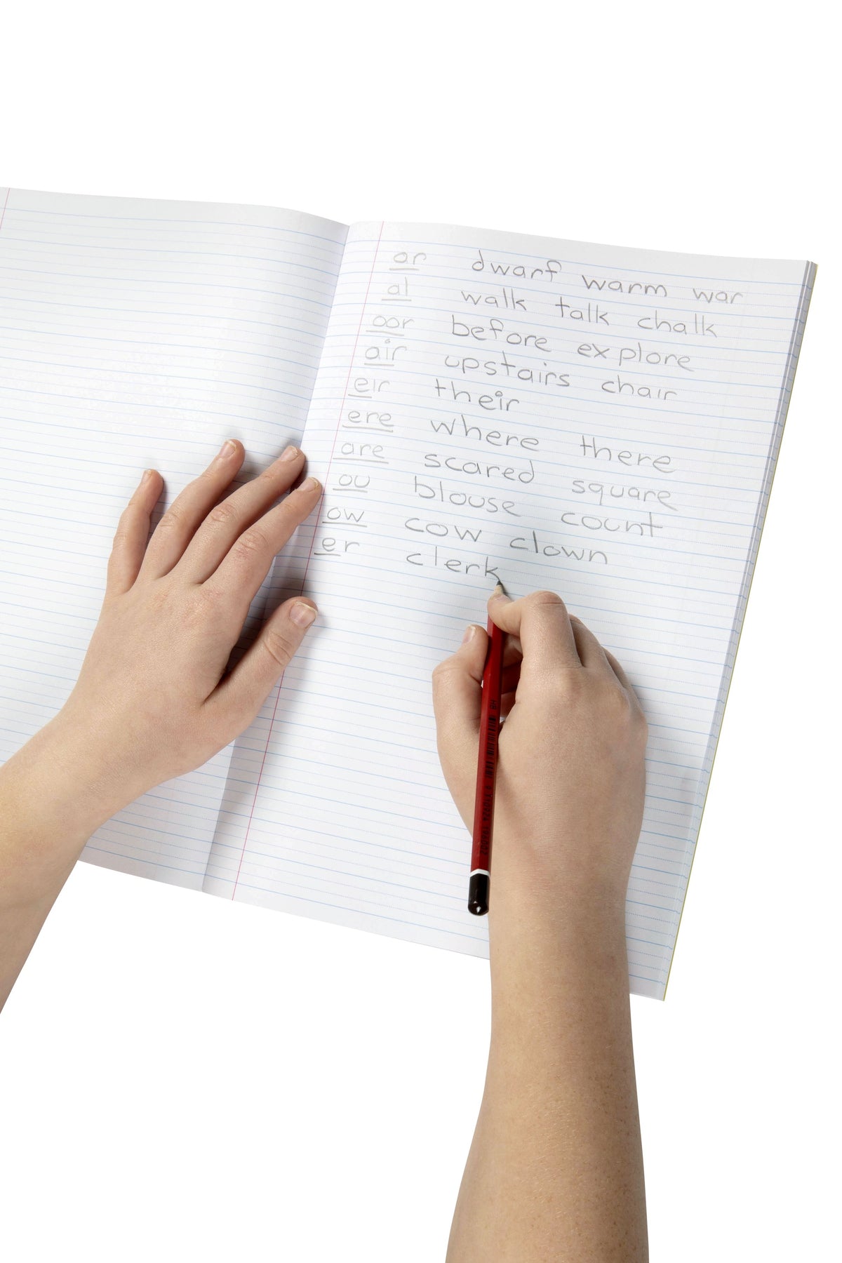 A child writing phonics word lists in pencil on the 14mm dotted thirds pages of an open Spirax P107 exercise book