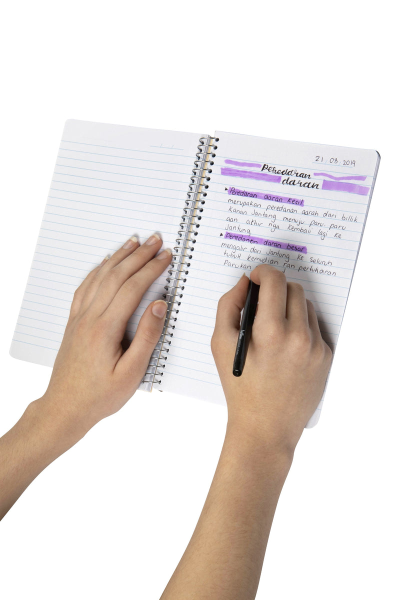 Hands writing highlighted study notes on a ruled page of a Spirax Kode A5 note book with silver wire binding
