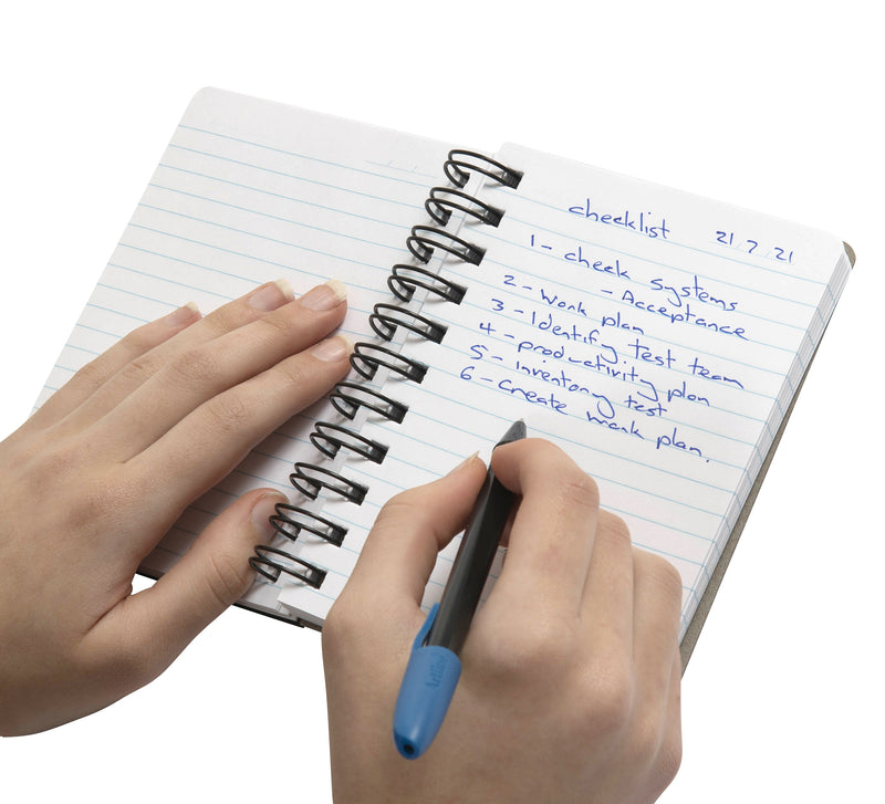 Hand writing a numbered checklist in a Spirax Kode P962 notebook held open on its black wire loops