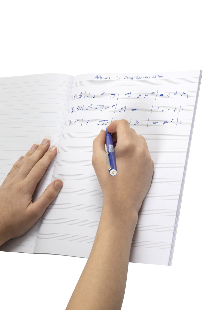 Hand writing music notation in pen onto the five line staves of an open Spirax 244 music book, with a second page of blank staves below