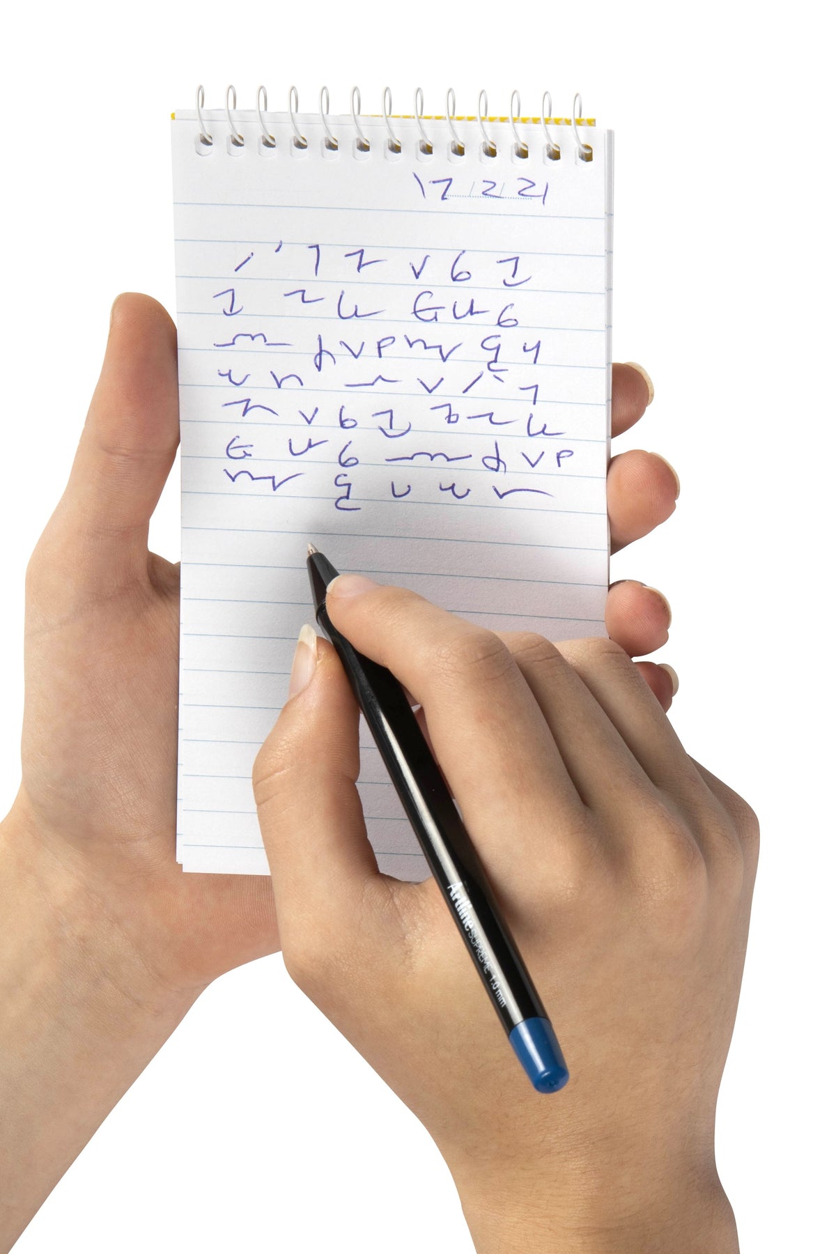 Hand holding a Spirax No. 541 top opening note pad and writing on its ruled page with a black pen