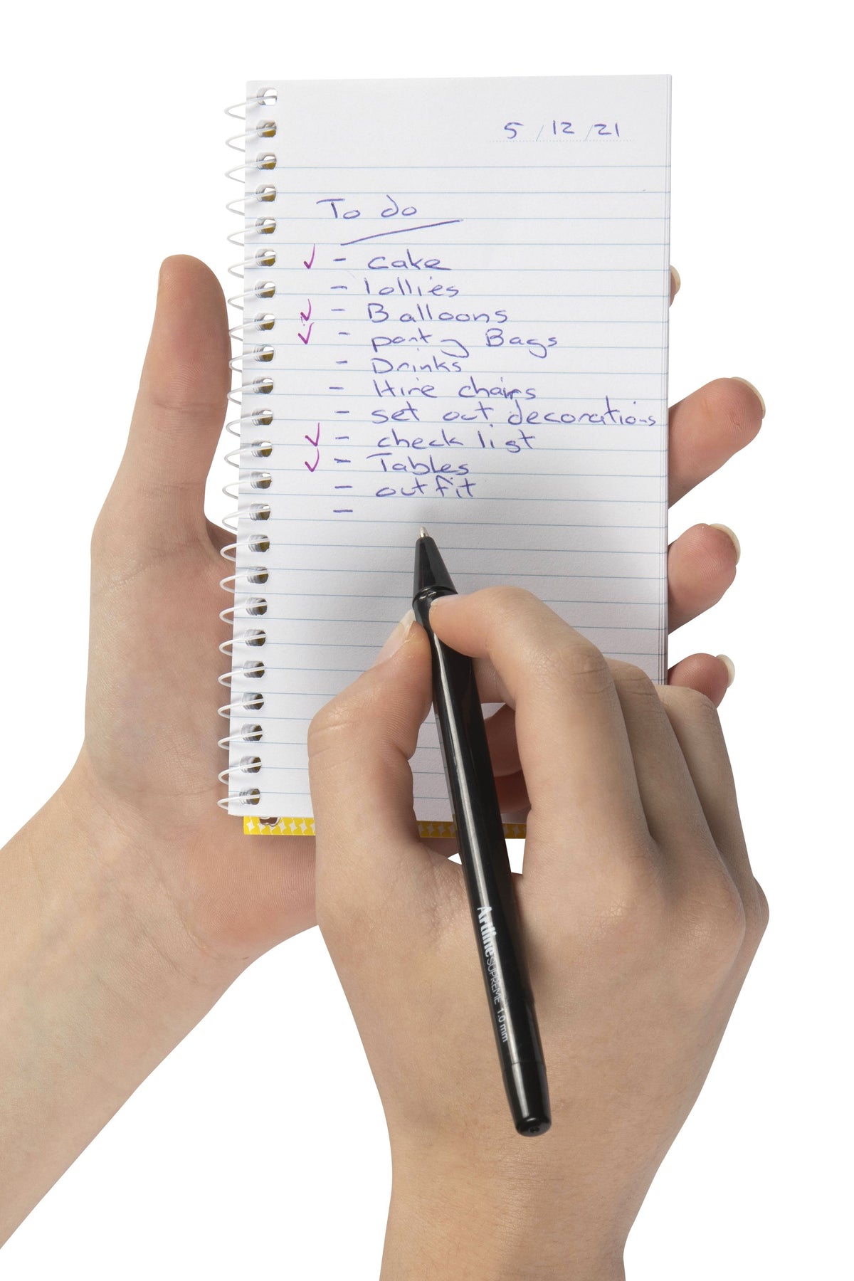 Spirax No. 561 notebook held upright in one hand with a handwritten to do list on the ruled page and a black pen in the other hand