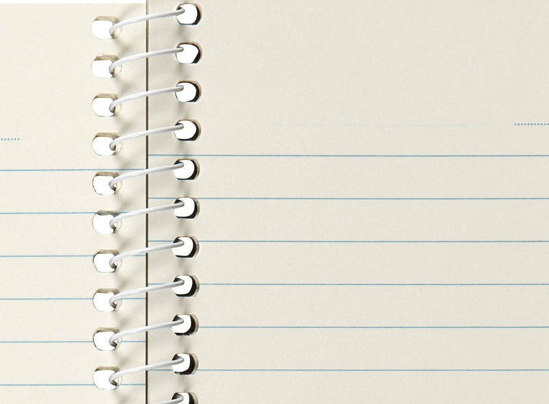 Close-up of Spirax 813 ruled lines next to the white spiral, showing the dotted date line across the top of the small page
