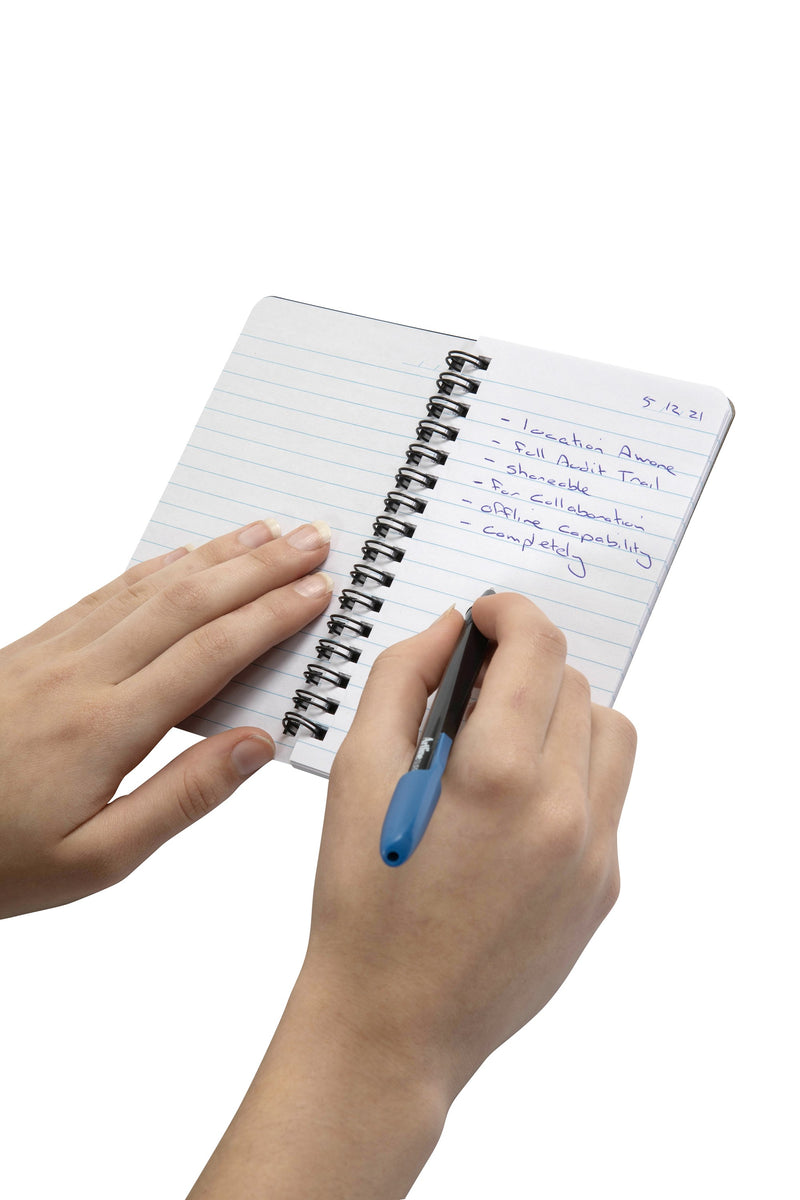 Spirax P561 side opening notebook held open on its black twin wire while notes are written in blue pen on a ruled page