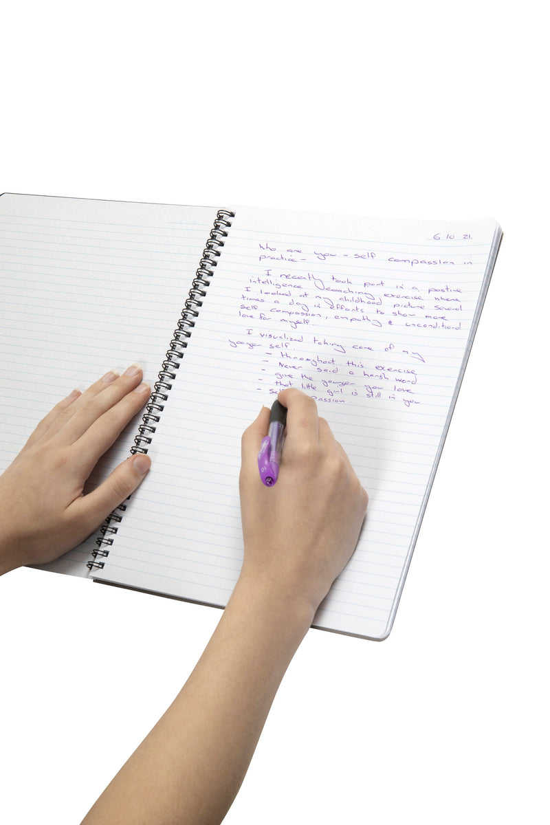 Hand writing notes in purple ink in an open Spirax P595 notebook folded back on its black twin wire, showing the ruled page with a date line at the top