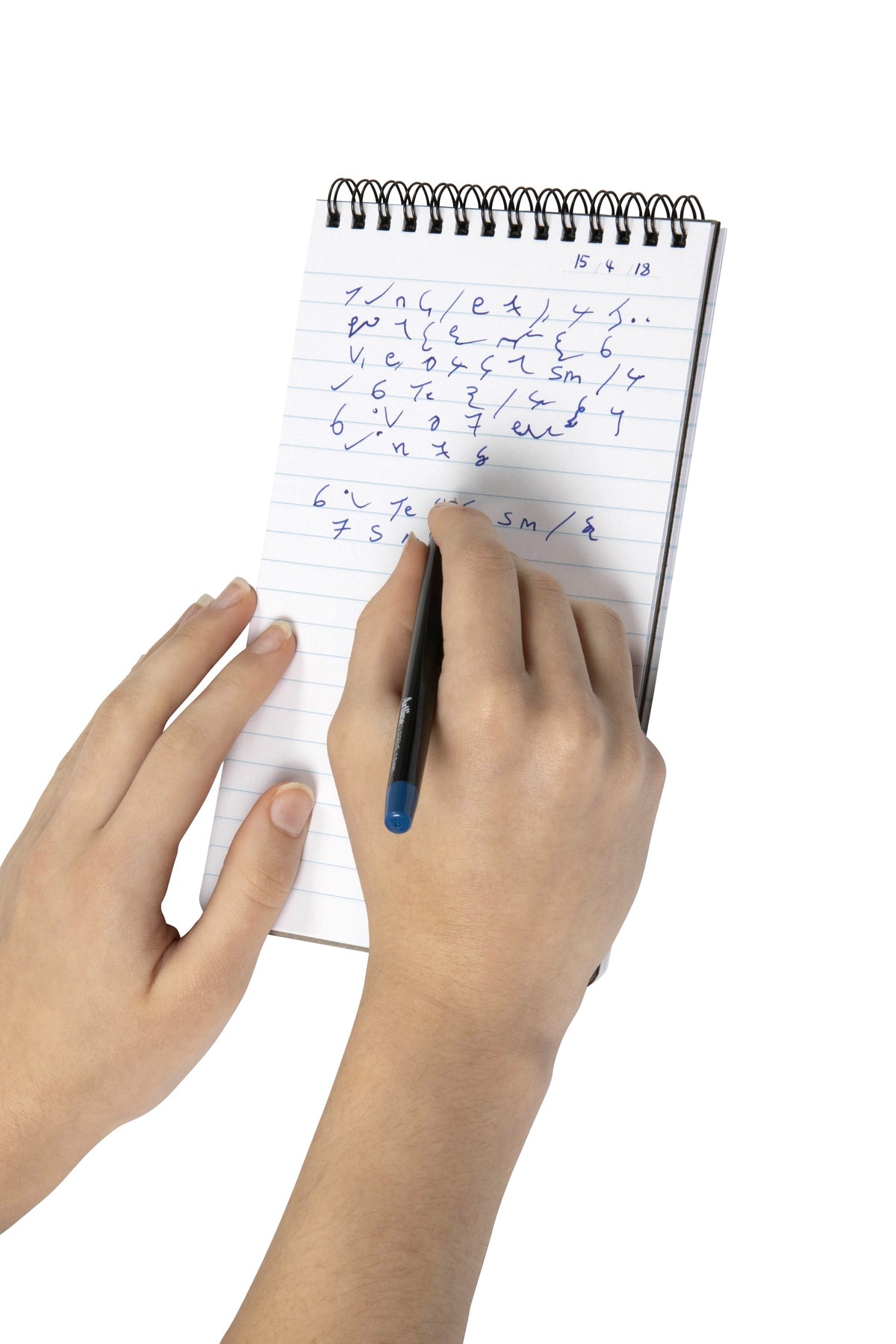 Spirax P563 reporters pad held in one hand while shorthand notes are written on the ruled page, black twin wire binding across the top