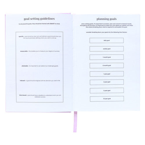 Spirax goals journal open at printed goal setting guidelines opposite a planning goals page divided into time frame boxes