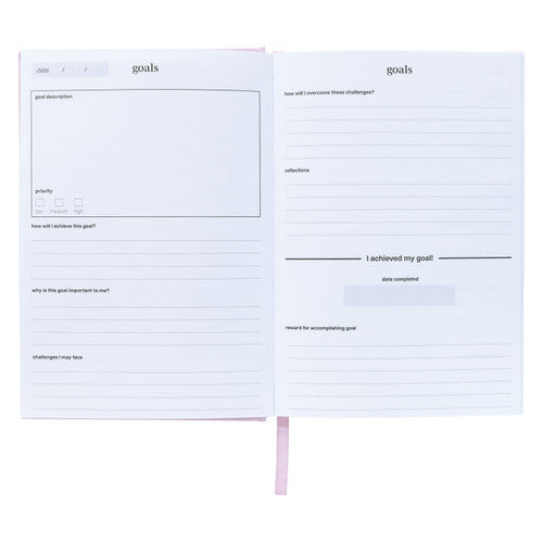 Goals page spread in the Spirax journal with boxes for goal description and priority and a line to record I achieved my goal