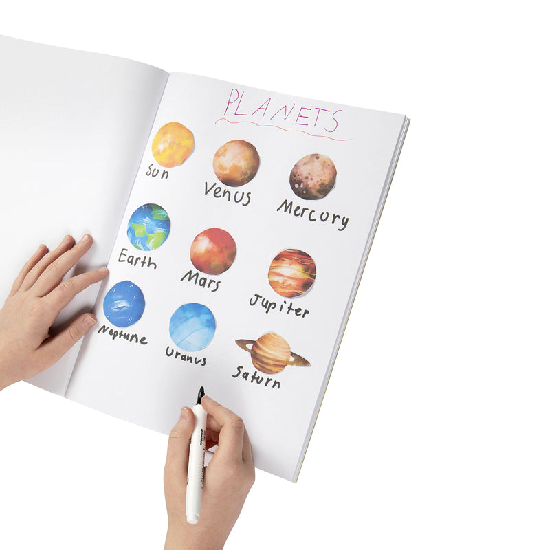 Hand drawing and labelling the sun and planets across a page of an open Spirax scrapbook with a marker