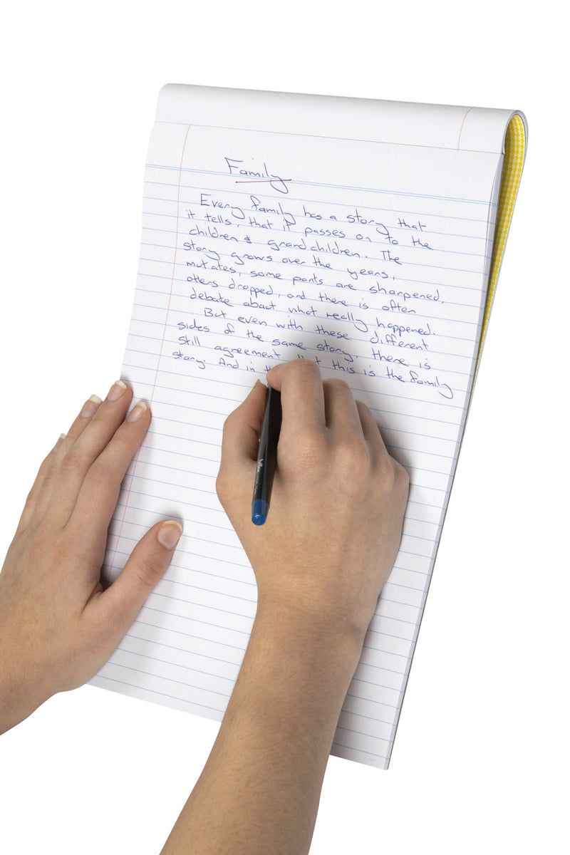 Hands writing a short story in blue pen on the ruled pages of a top bound Spirax A4 writing pad, with the yellow checked cover showing at the edge