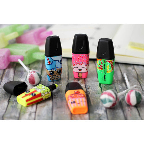 Stabilo Boss Mini Sweet Friends pen held in hand highlighting text on a document