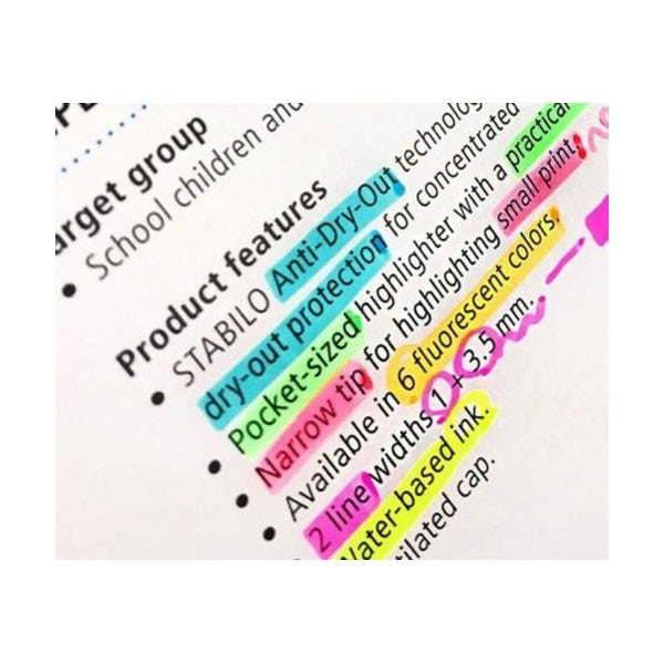 Stabilo Flash highlighter marking text in a notebook with vivid yellow fluorescent ink