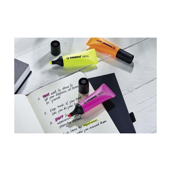 Stabilo Neon green highlighter marking text in a notebook