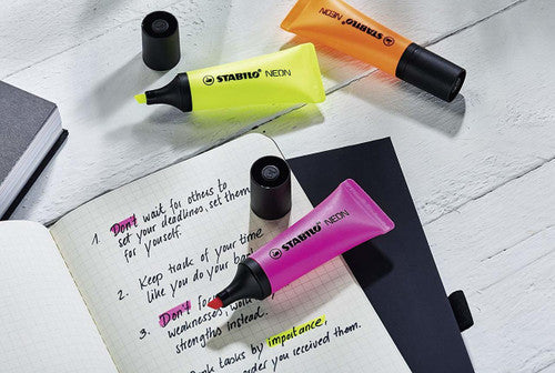 Stabilo Neon Orange Highlighter marking a wide yellow-orange line on white paper