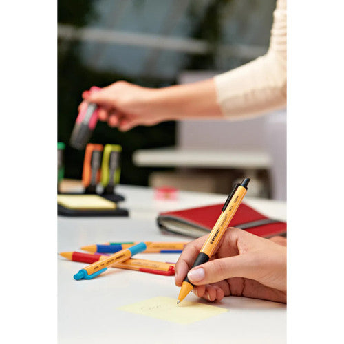 Side view of all four Stabilo Pointball pens lined up on a desk surface