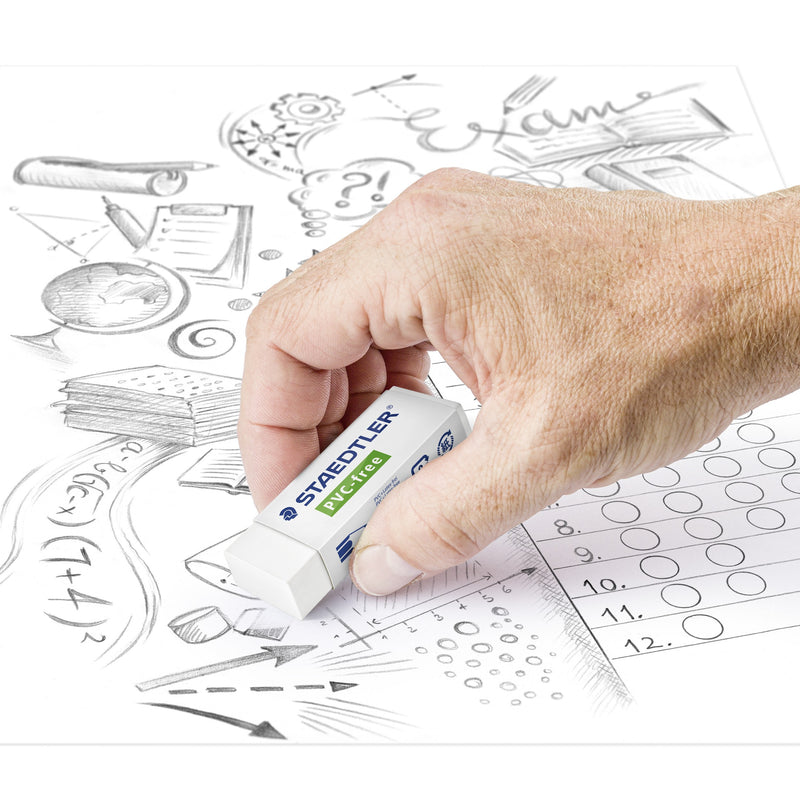 Hand rubbing out pencil marks on a sheet of exam doodles and answer bubbles with a Staedtler PVC-free eraser