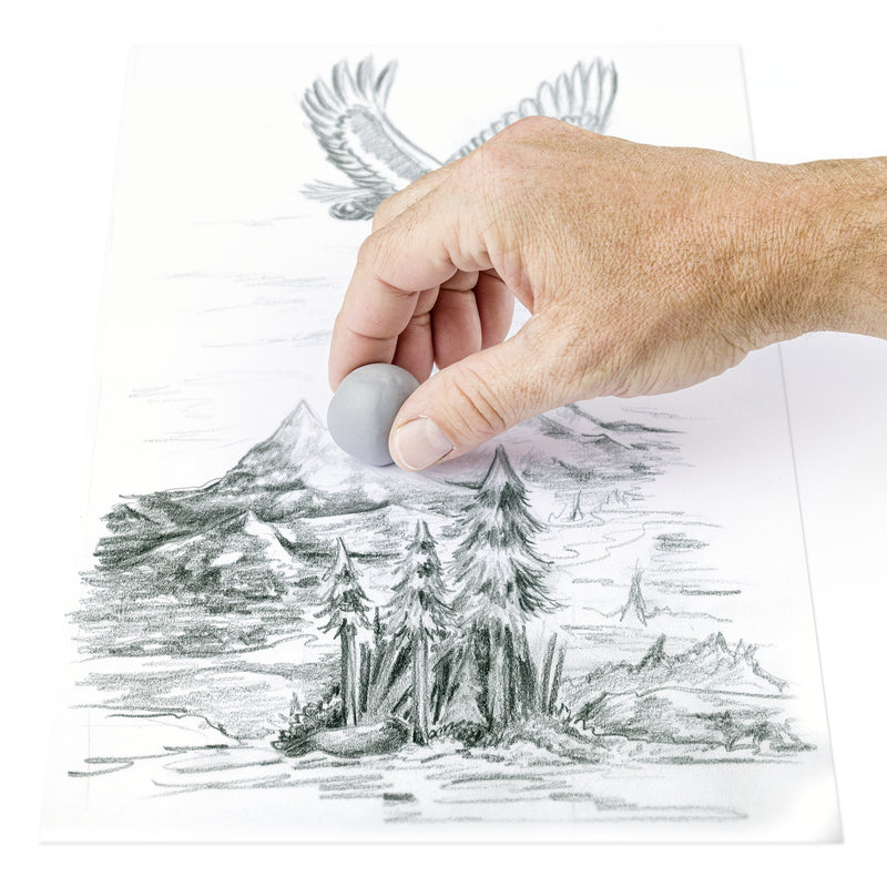 Hand pressing a kneaded grey Staedtler eraser on a pencil landscape of trees, mountains and an eagle