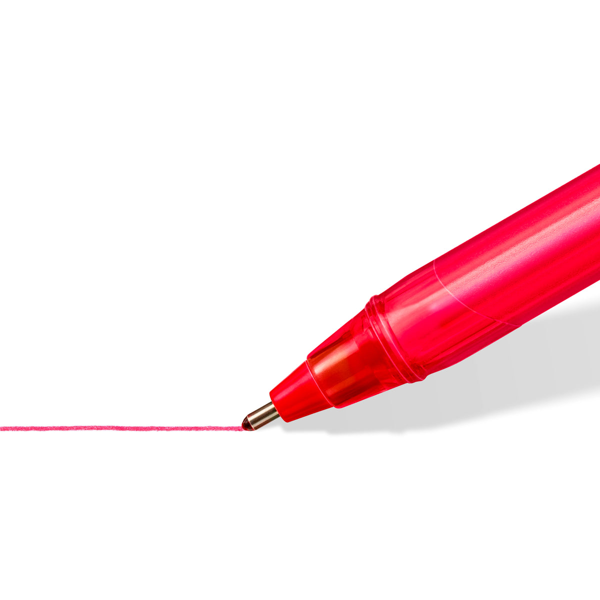 Close-up of the medium tip of a red Staedtler ball 4320 ballpoint pen drawing a red line on white paper