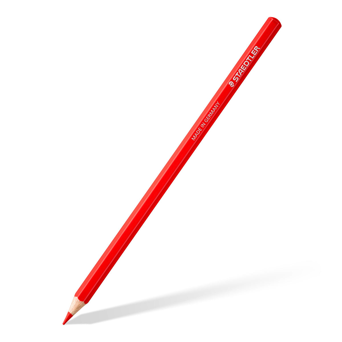 Single Staedtler 146C coloured pencil, red hexagonal barrel and sharpened tip, at an angle on white