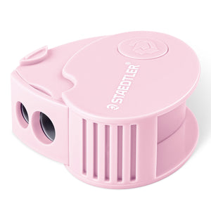 Pastel pink Staedtler covered sharpener, rounded body with ribbed sides, two holes at the front and STAEDTLER moulded on the lid