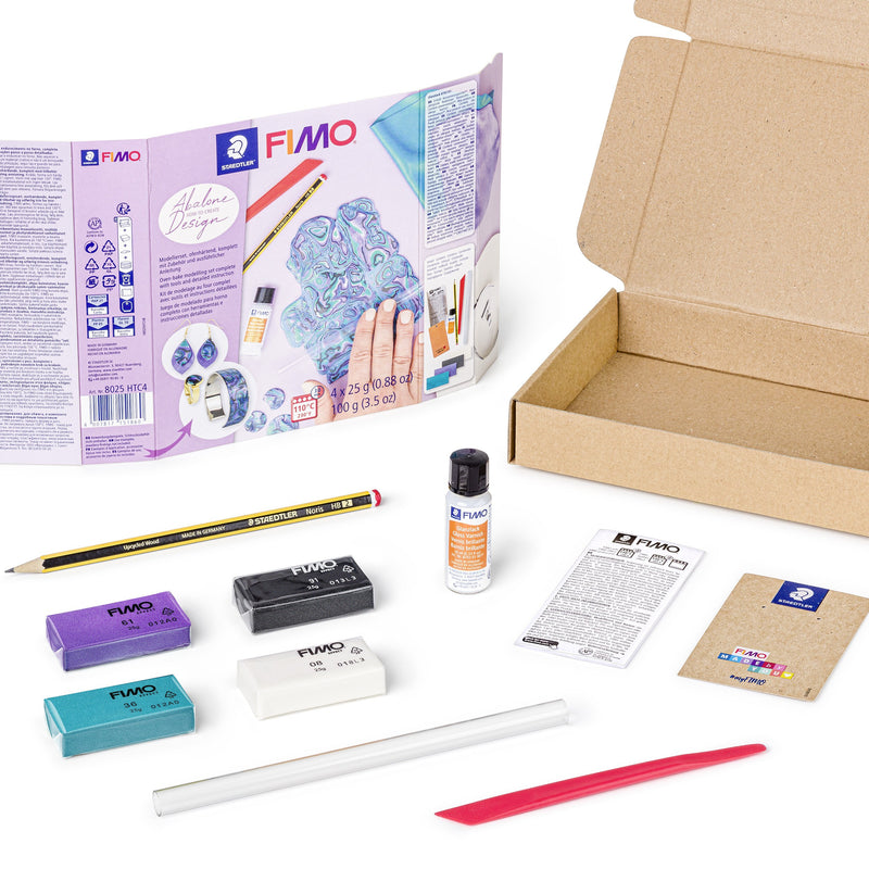 Contents of the FIMO abalone design set: four clay half blocks, a small gloss varnish bottle, roller, modelling stick, pencil and leaflet