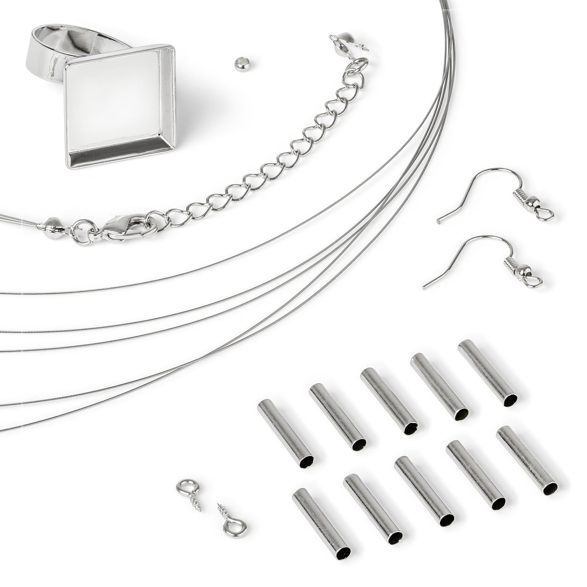Close view of the FIMO findings: square tray ring blank, coiled necklace wire, chain with lobster clasp, earring hooks, metal tubes and eye pins