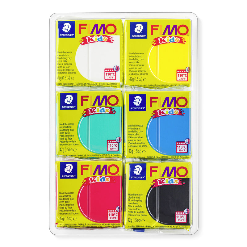 Six wrapped FIMO kids blocks in a clear tray: white, yellow, turquoise green, blue, red and black