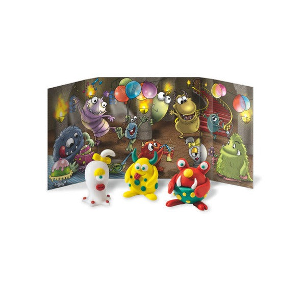 Three clay monsters in front of a monster party backdrop with balloons