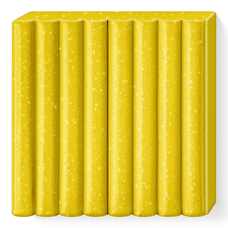 Unwrapped glitter gold FIMO kids block 8030-112 in a sparkling gold colour, scored into 8 portions