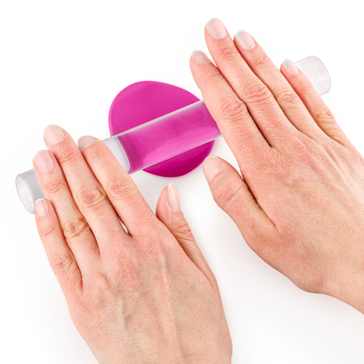A clear acrylic roller pressing a sheet of FIMO soft flat, shown in a pink shade to demonstrate rolling out clay