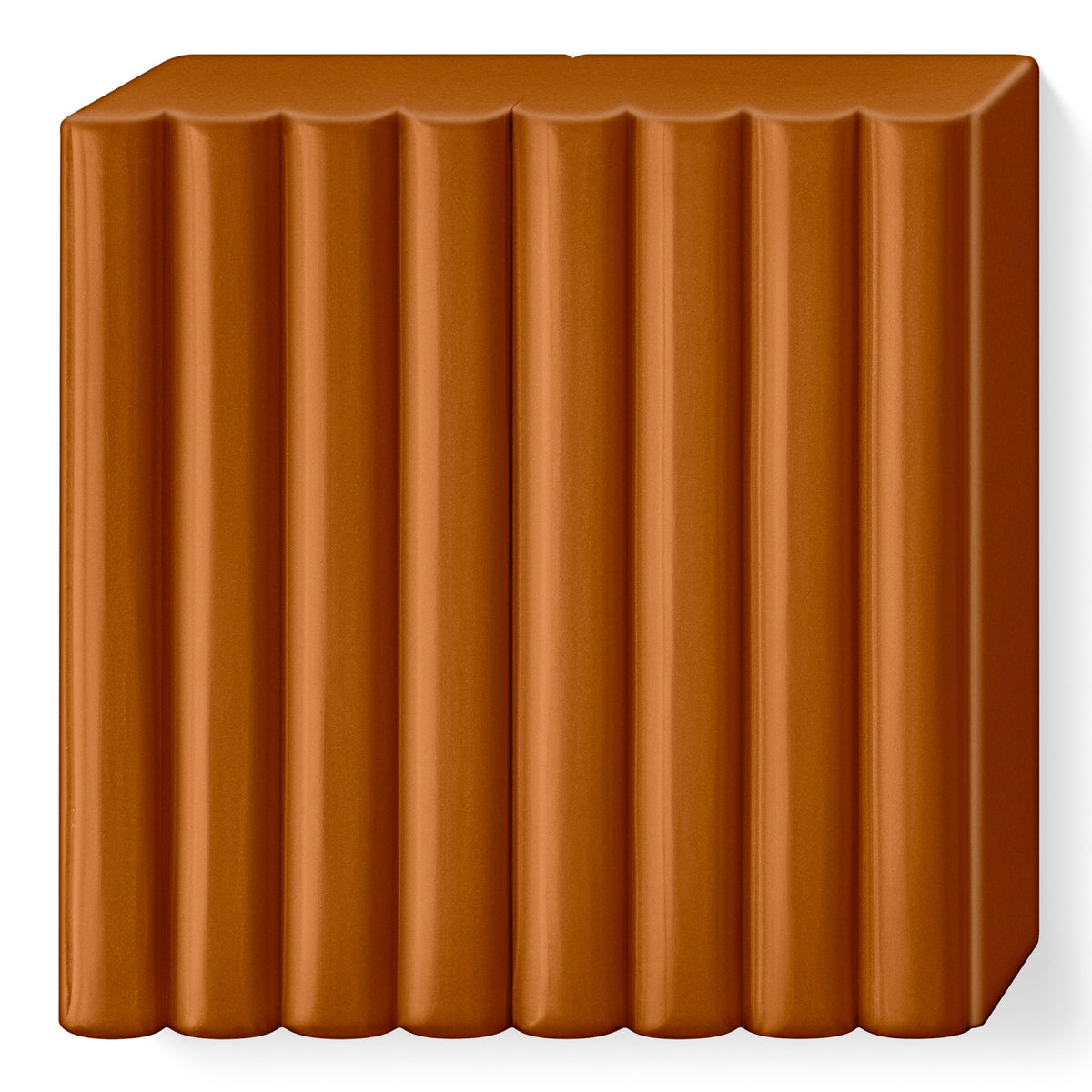FIMO soft caramel block out of its wrapper, a warm light brown slab scored into 8 portions
