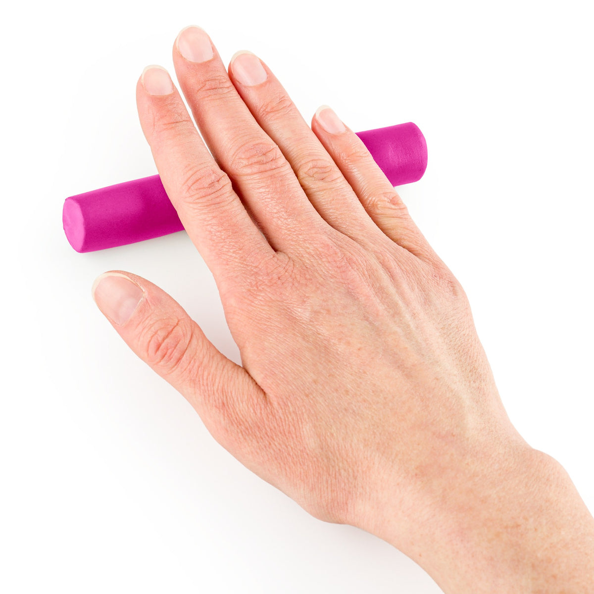 Flat hand rolling FIMO soft into a long, even log on a white surface, shown with pink clay