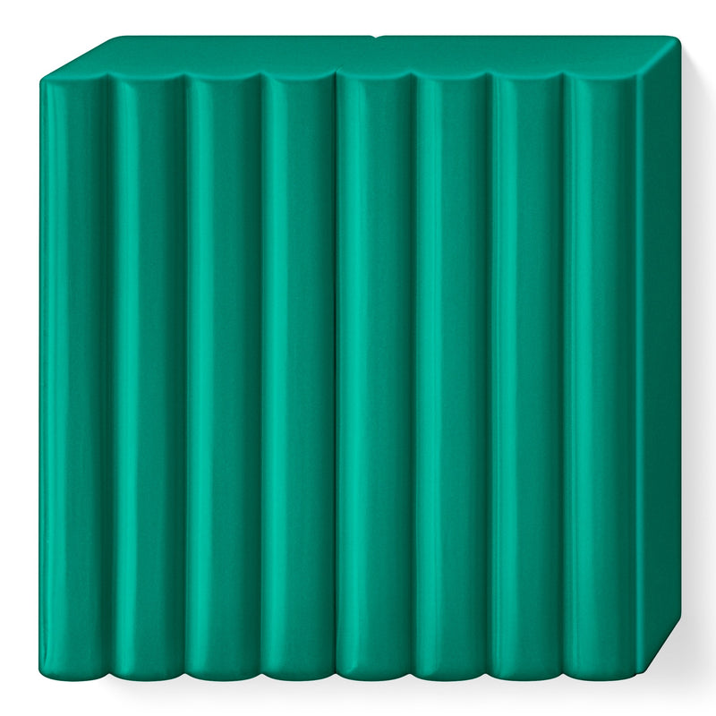 FIMO soft emerald block without its wrapper, a deep blue green slab marked into 8 portions