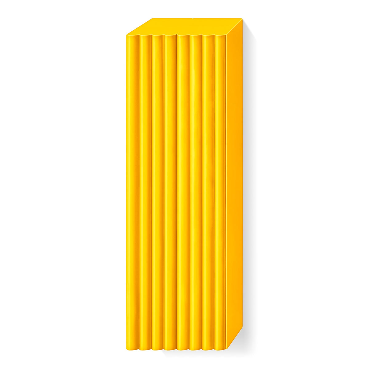 Sunflower yellow FIMO soft large block unwrapped, with raised ridges marking the portions along its length