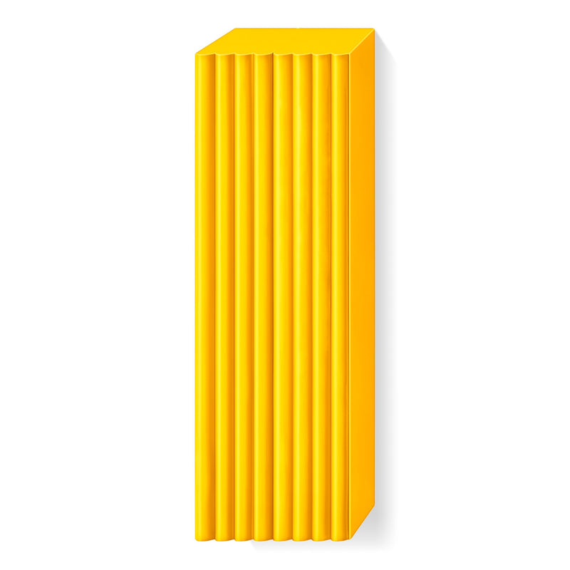 Sunflower yellow FIMO soft large block unwrapped, with raised ridges marking the portions along its length