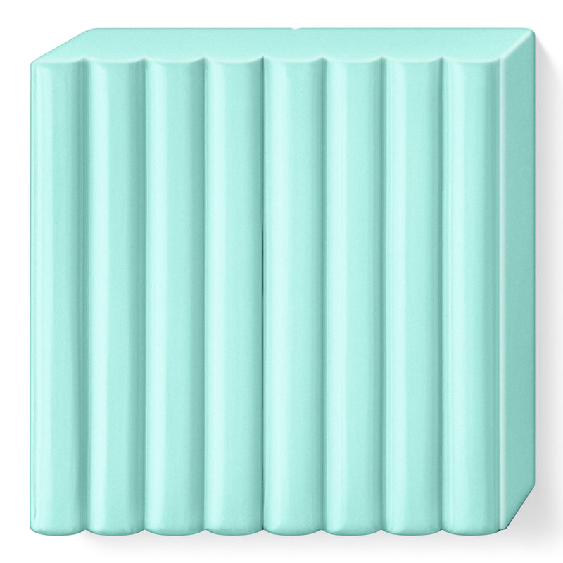 Unwrapped FIMO soft mint block, a pale cool green slab ribbed into portions