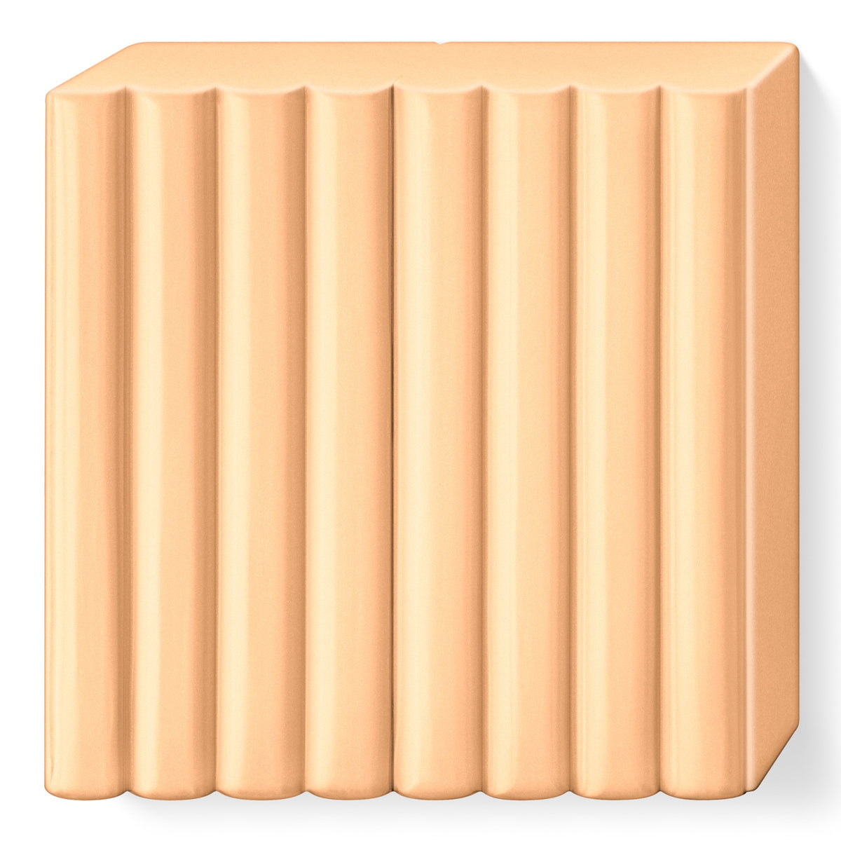 Peach FIMO soft clay block unwrapped, showing the grooves that split it into portions