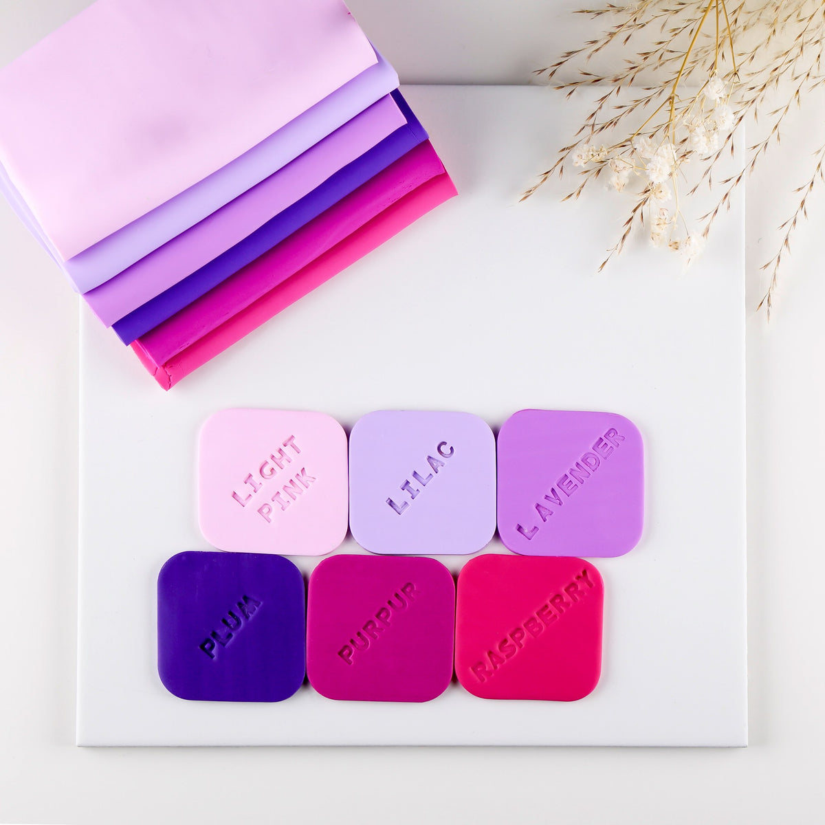 Staedtler colour board of FIMO soft tiles: light pink, lilac, lavender, plum, purple stamped PURPUR, and raspberry