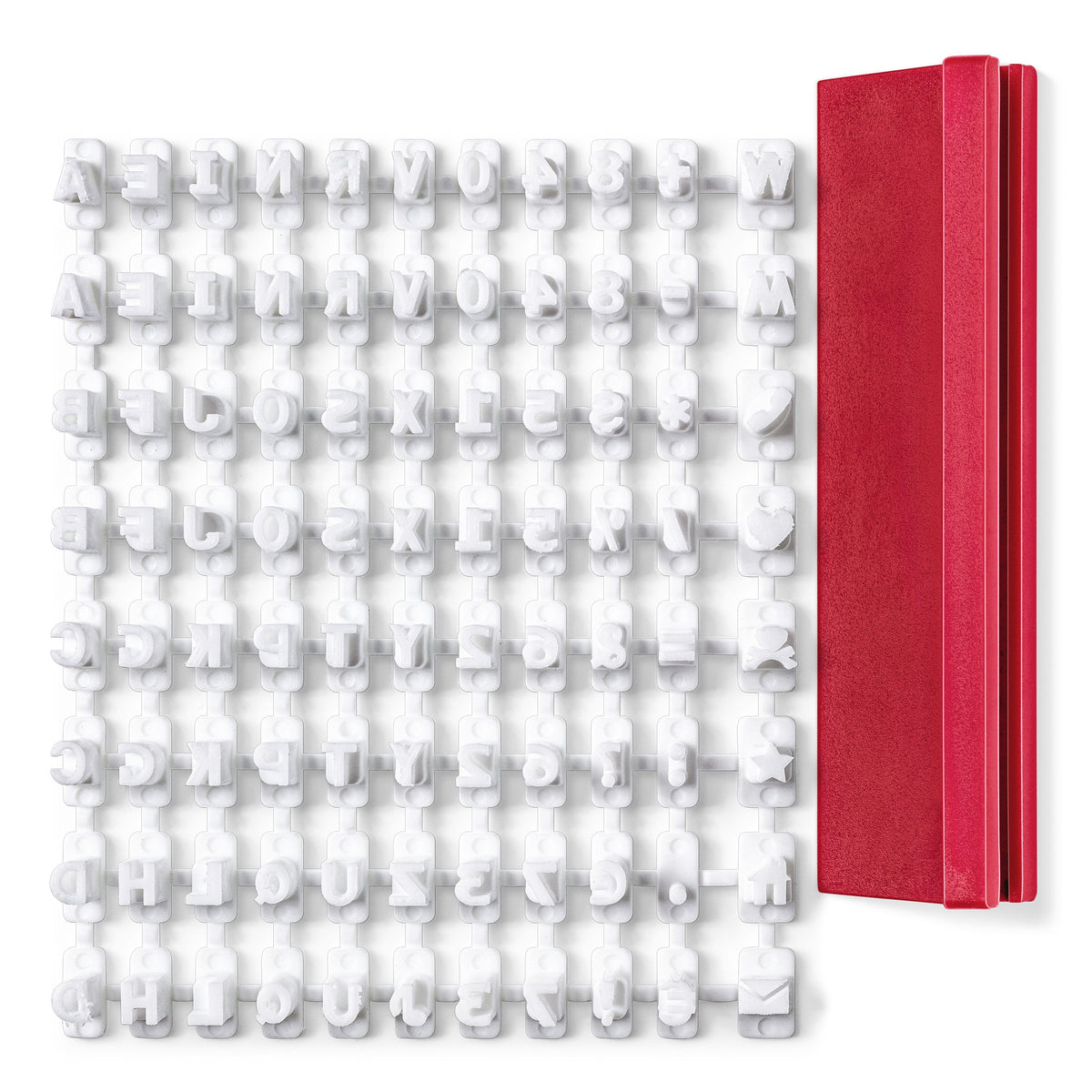 Sheet of white FIMO stamp kit characters still on the sprue next to the red plastic holder