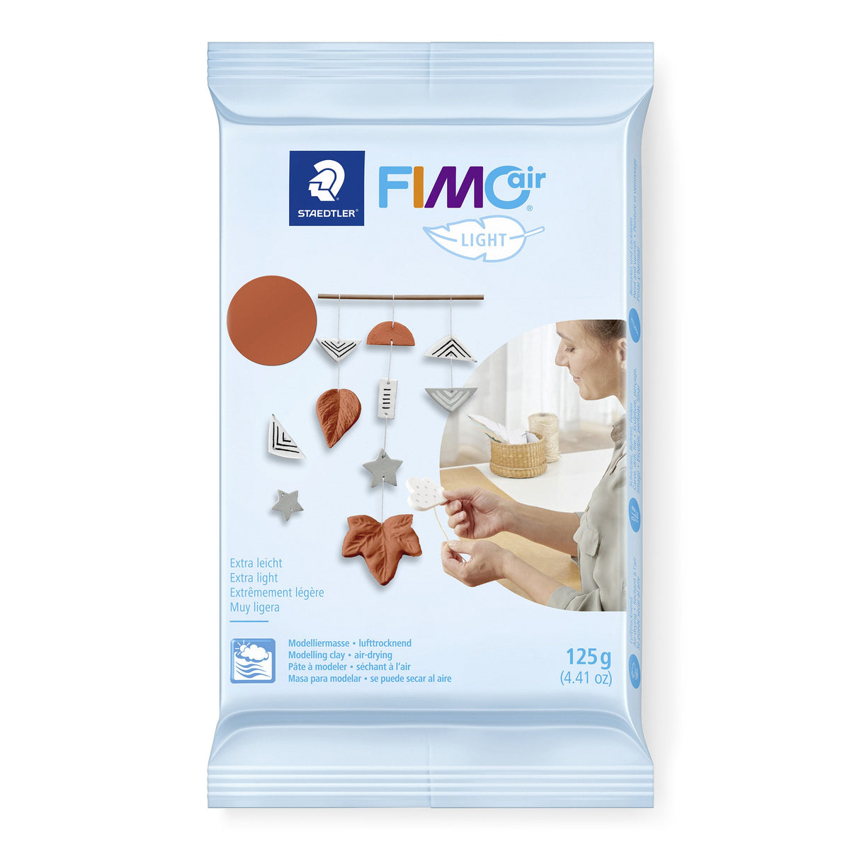 Staedtler FIMOair light 125 g pack with a terracotta colour dot and a wall hanging of leaf and star shapes on the front