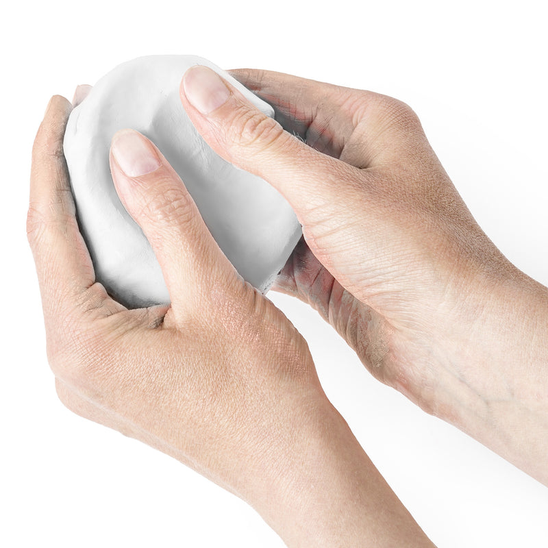 Hands working a ball of white FIMOair light to warm and soften it