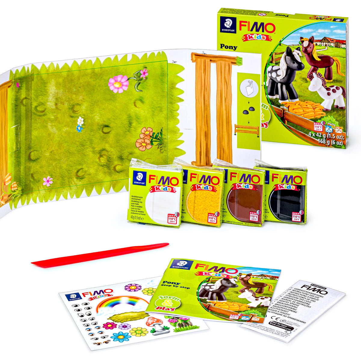 Contents of the FIMO kids Pony set: four wrapped clay blocks, a fold-out meadow play scene, a red modelling stick, an instruction booklet and a sticker sheet