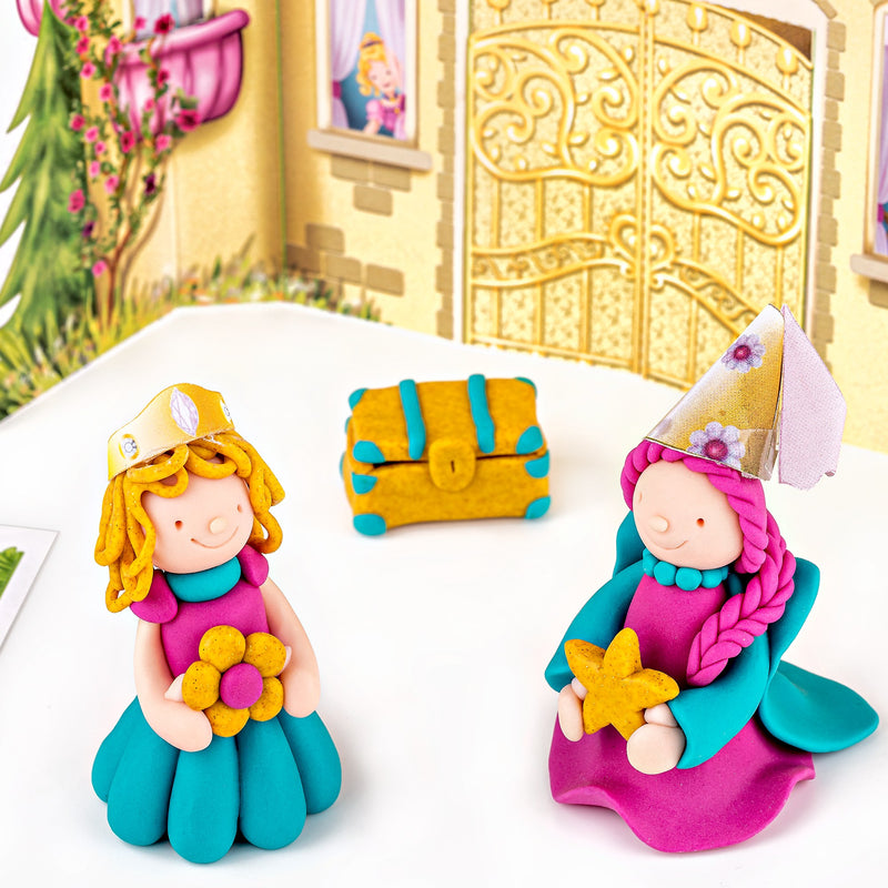 Two finished FIMO kids princesses in turquoise and pink with a small golden treasure chest in front of the castle gate backdrop